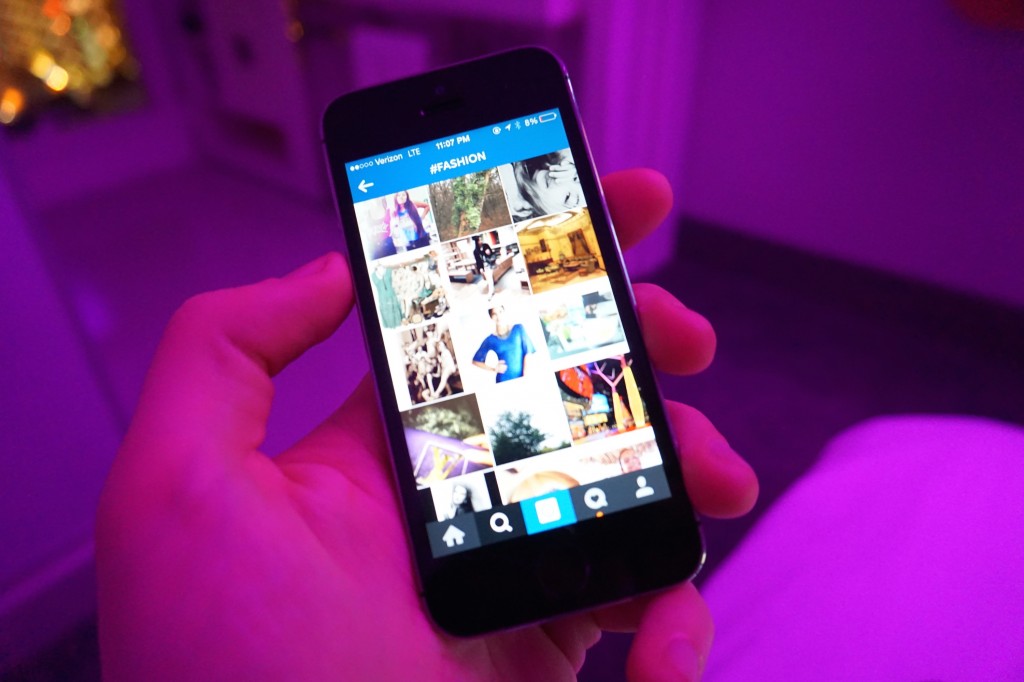 The instagram app open on an iPhone, showing photos tagged with the fashion hashtag.